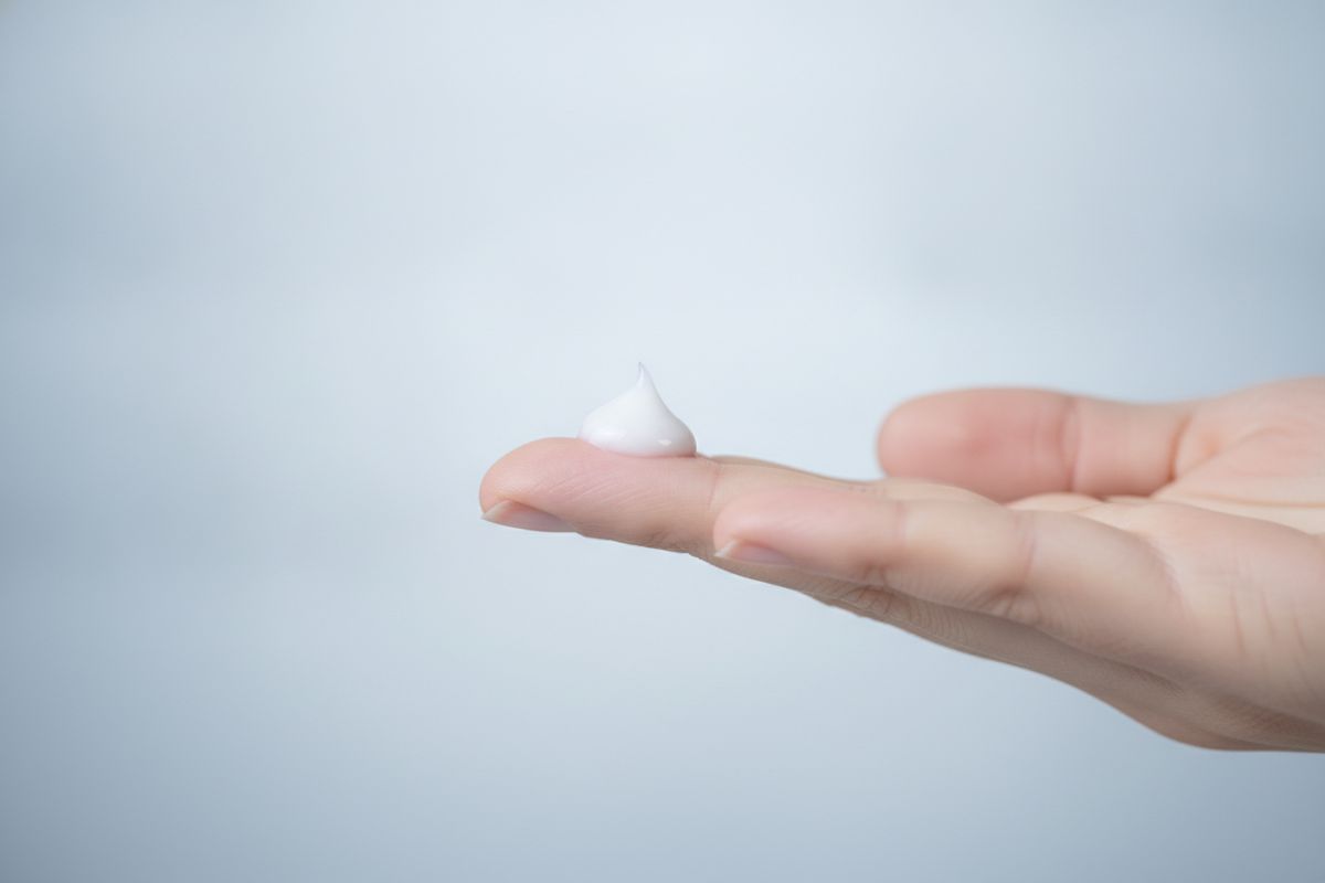 A drop of lotion on a fingertip